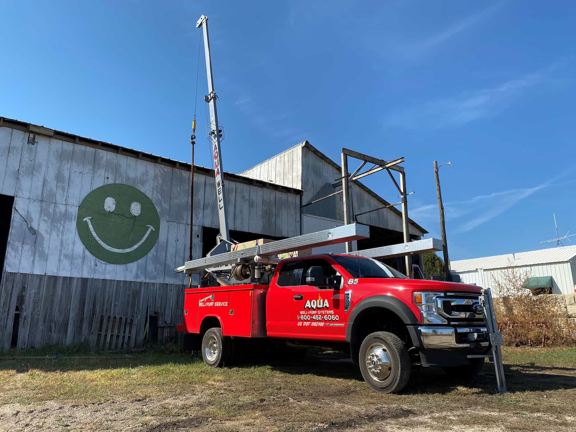 Aqua Well and Pump truck beside a Wisconsin barn